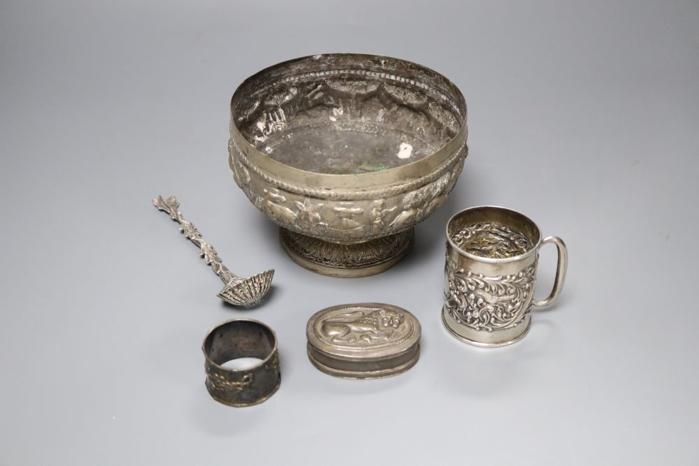 An Edwardian silver christening mug, a Victorian silver foliate sifter spoon, Indian? bowl, Chinese napkin ring & a snuff box.